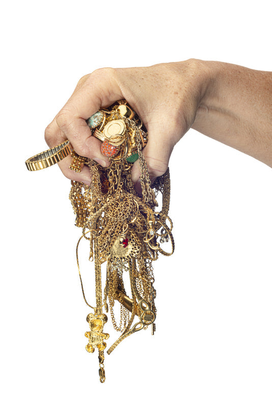 Hand holding tangled jewelry chain 