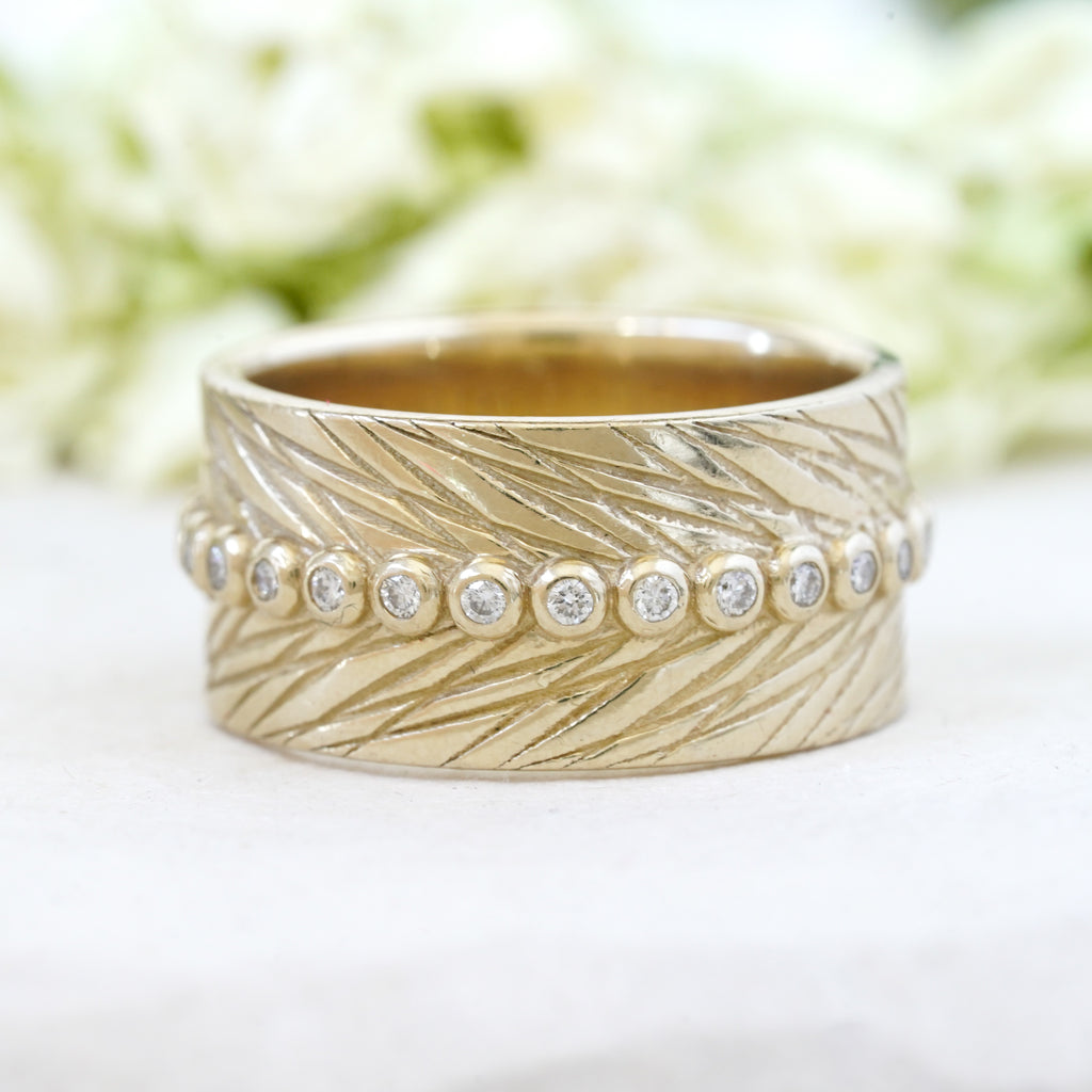 Wide feather wedding band with diamonds