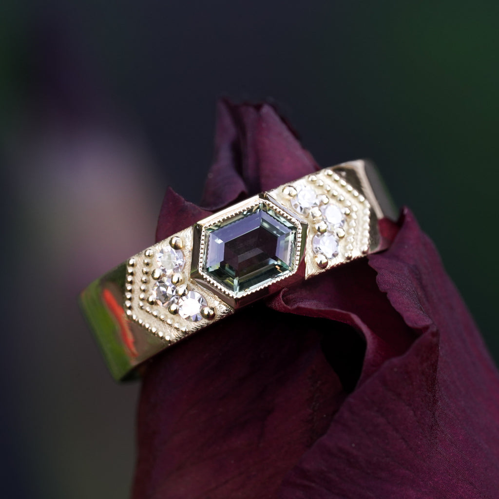 18k yellow gold green hexagon Montana sapphire with heirloom diamonds in a wide wedding band with milgrain detailing