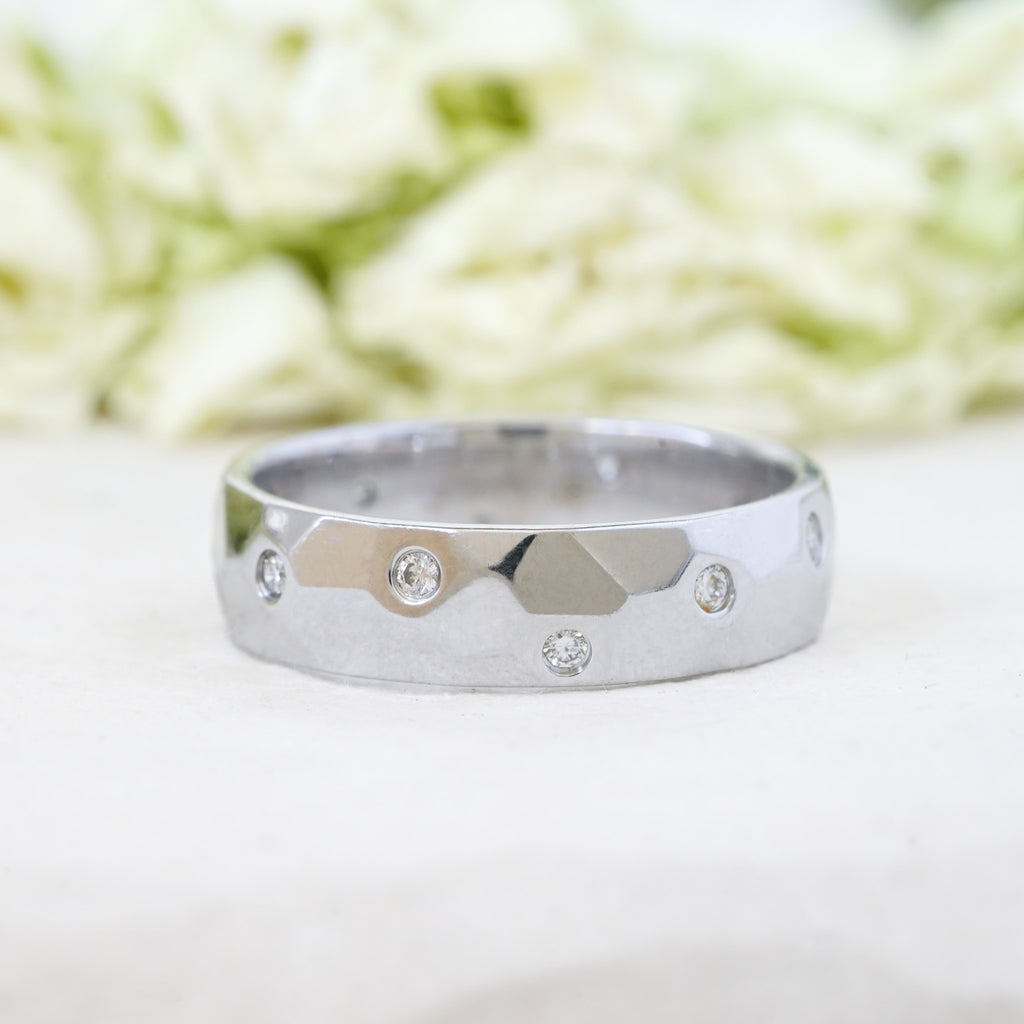 modern minimalist diamond wedding band in white gold with flush set diamonds