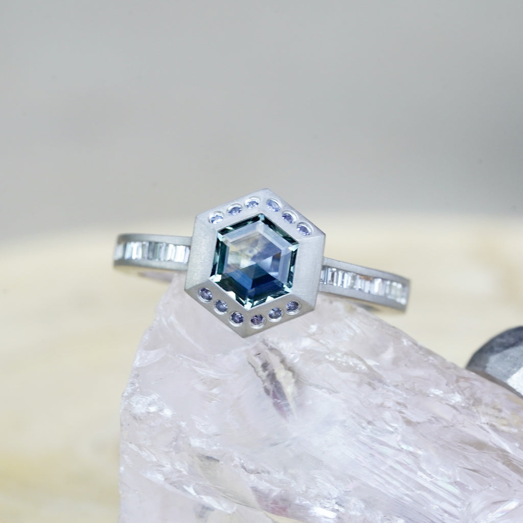 Yogo sapphire thick walled bezel surrounding a hexagon Montana Sapphire