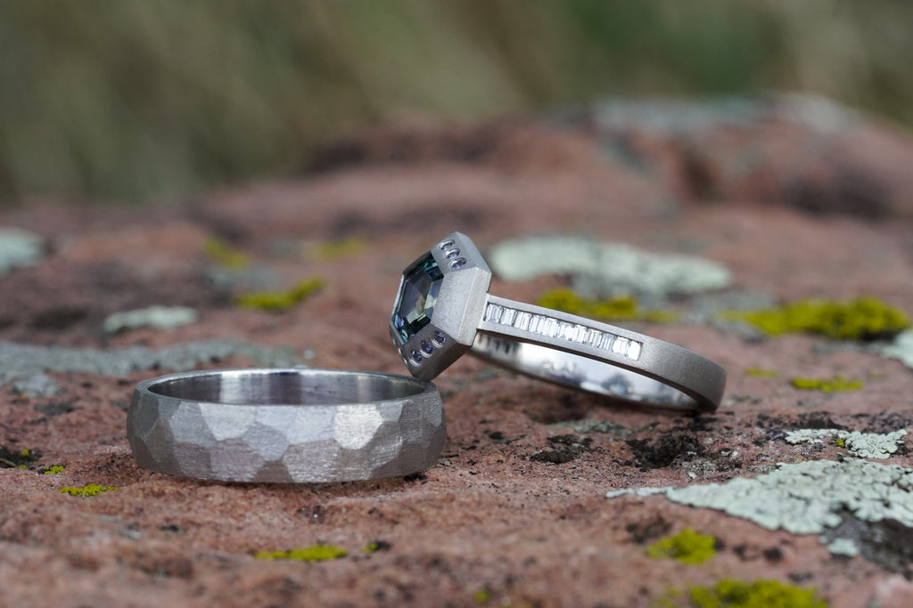 architectural solitaire ring with bezel set gemstone and channel set diamonds