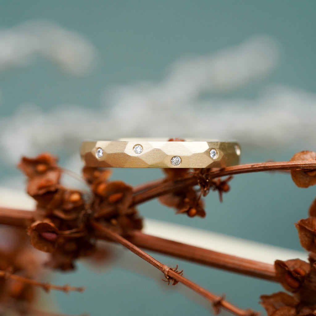 satin finish wide wedding band with hand-carved facets