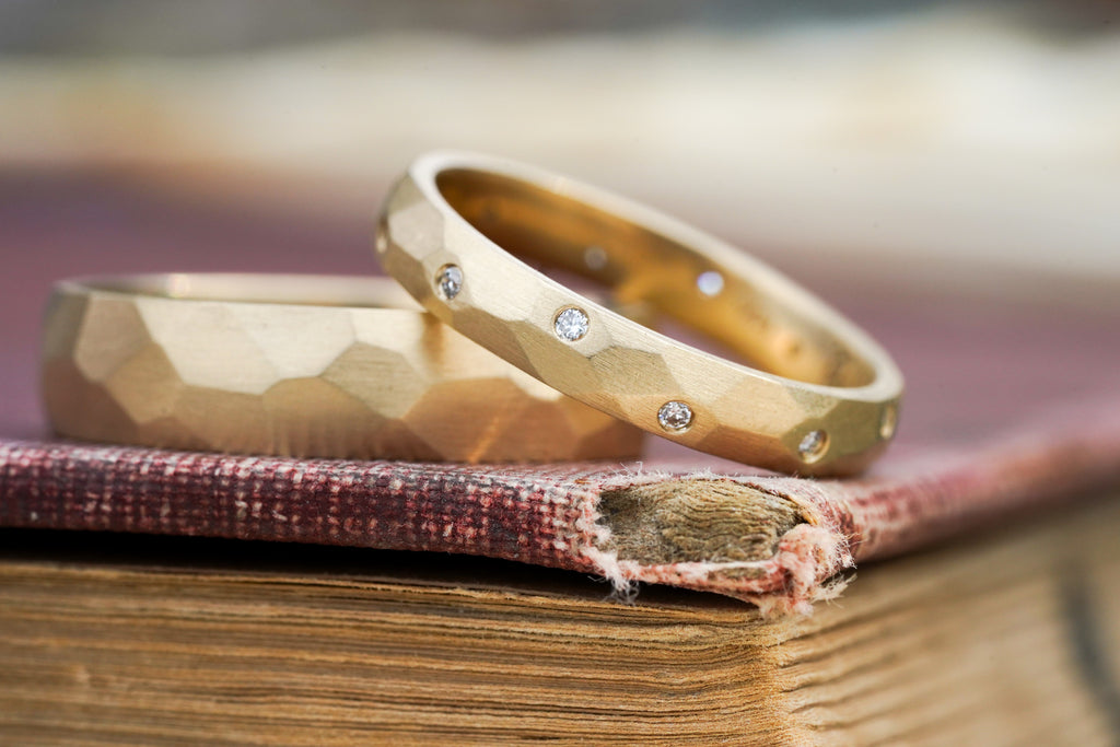 custom sculptural wedding ring in 14k gold with flush set diamonds