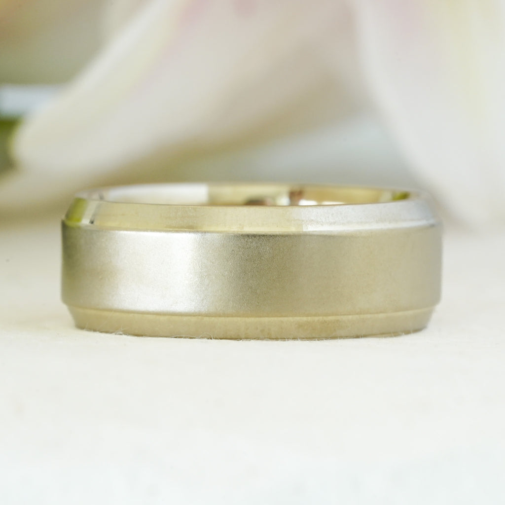 Chrysos men’s beveled edge wedding band in recycled yellow gold