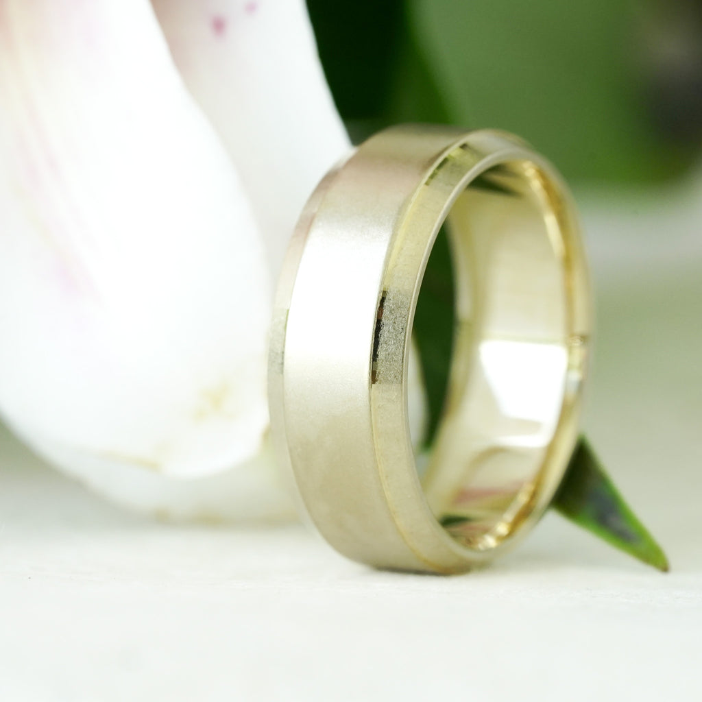 Chrysos men’s beveled edge wedding band in recycled yellow gold