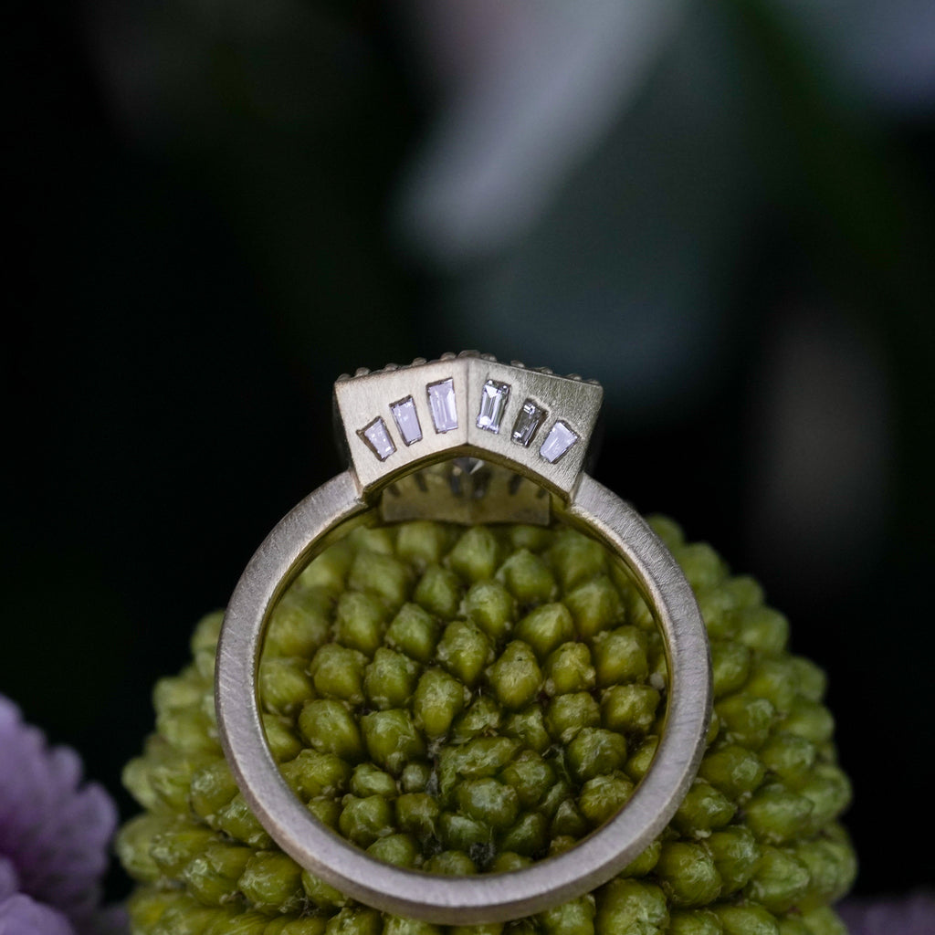 Vintage style heirloom engagement ring with hidden baguette accents