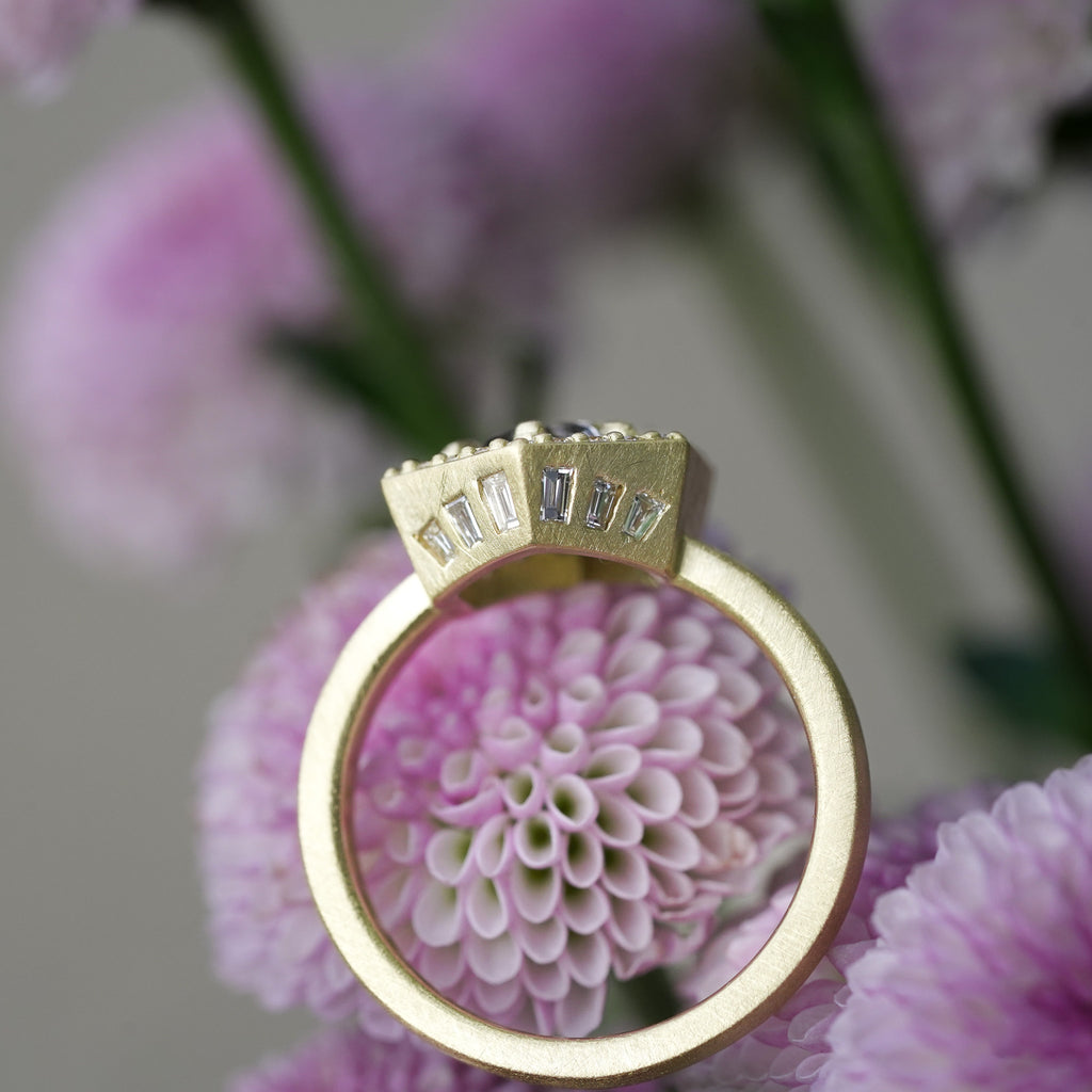 Antique style heirloom engagement ring with hidden baguette accents