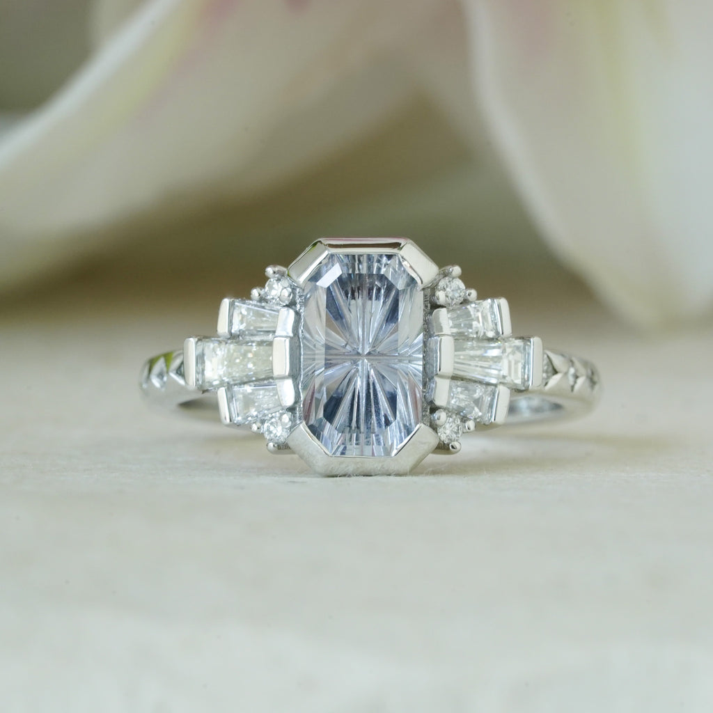Close-up of vintage glam engagement ring with tapered diamonds