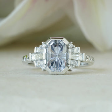 Close-up of vintage glam engagement ring with tapered diamonds