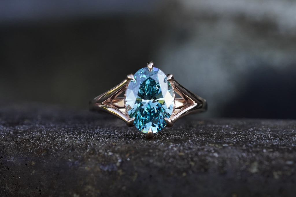 Timeless engagement ring in rose gold with blue oval diamond