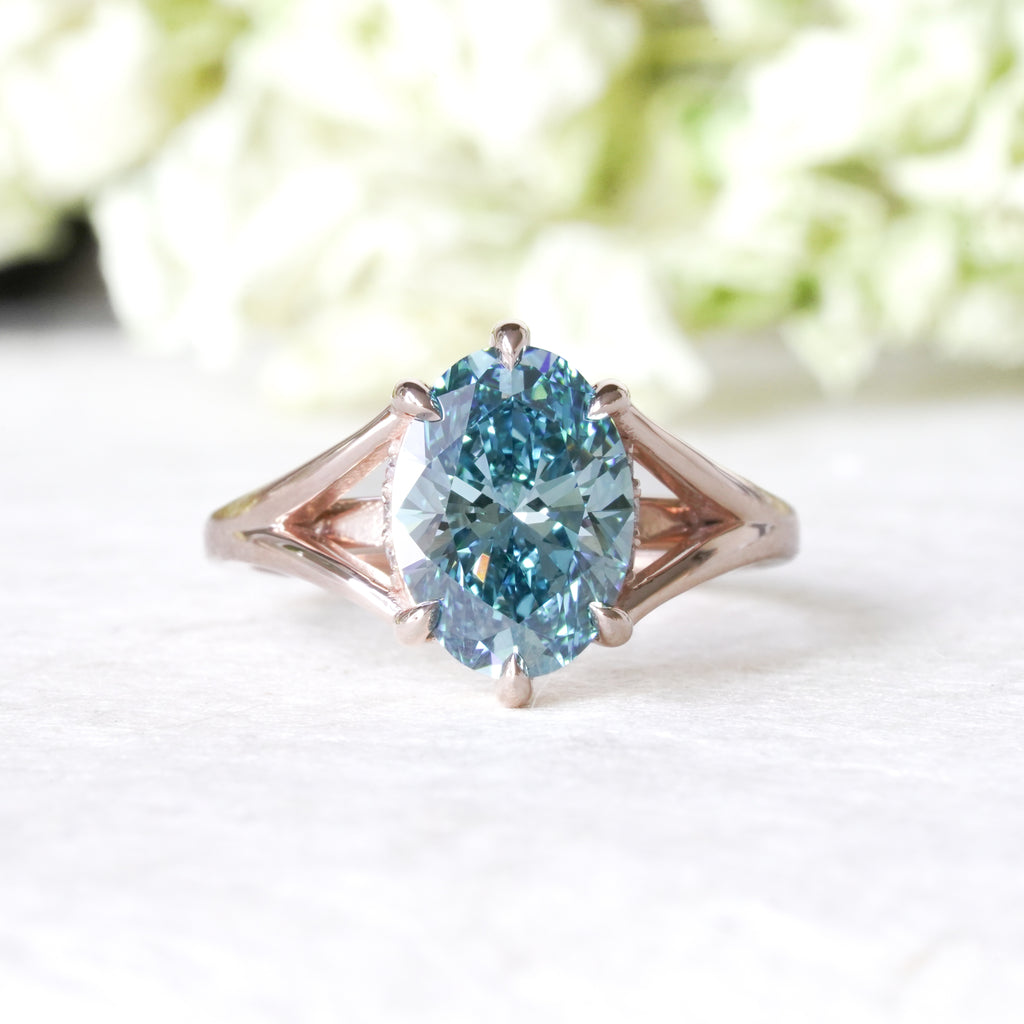 14k rose gold with lab blue oval diamond split shank engagement ring
