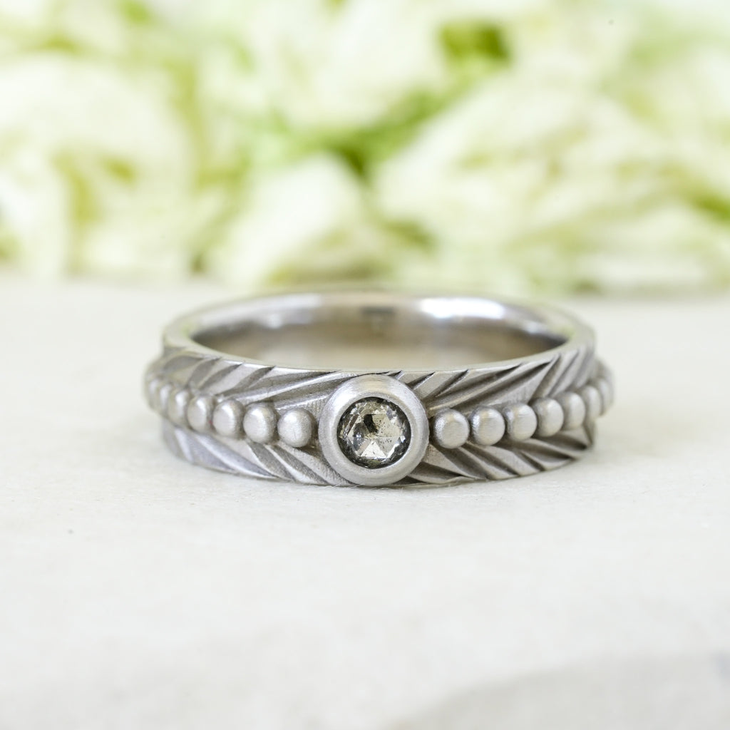 salt & pepper rosecut diamond bezel set in 14k white gold on a engraved feather boho wedding band
