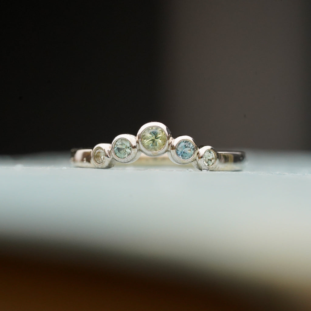 Round bezel montana sapphire contour wedding band 