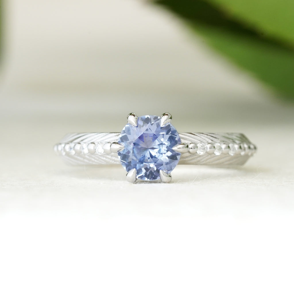 sapphire engagement ring with a diamond feather spine in 14k white gold 