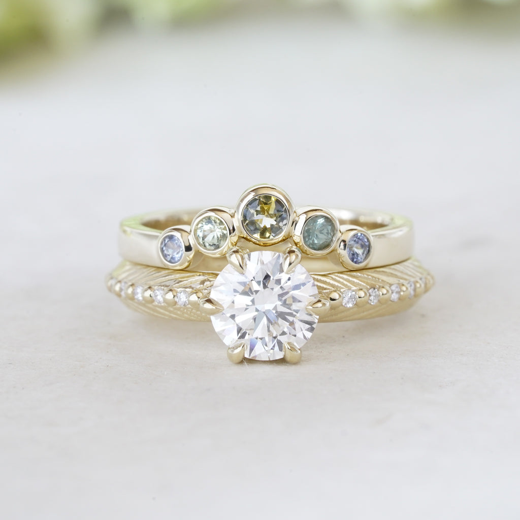 boho engagement ring with diamond and feather pattern with a ombré sapphire contour band on top