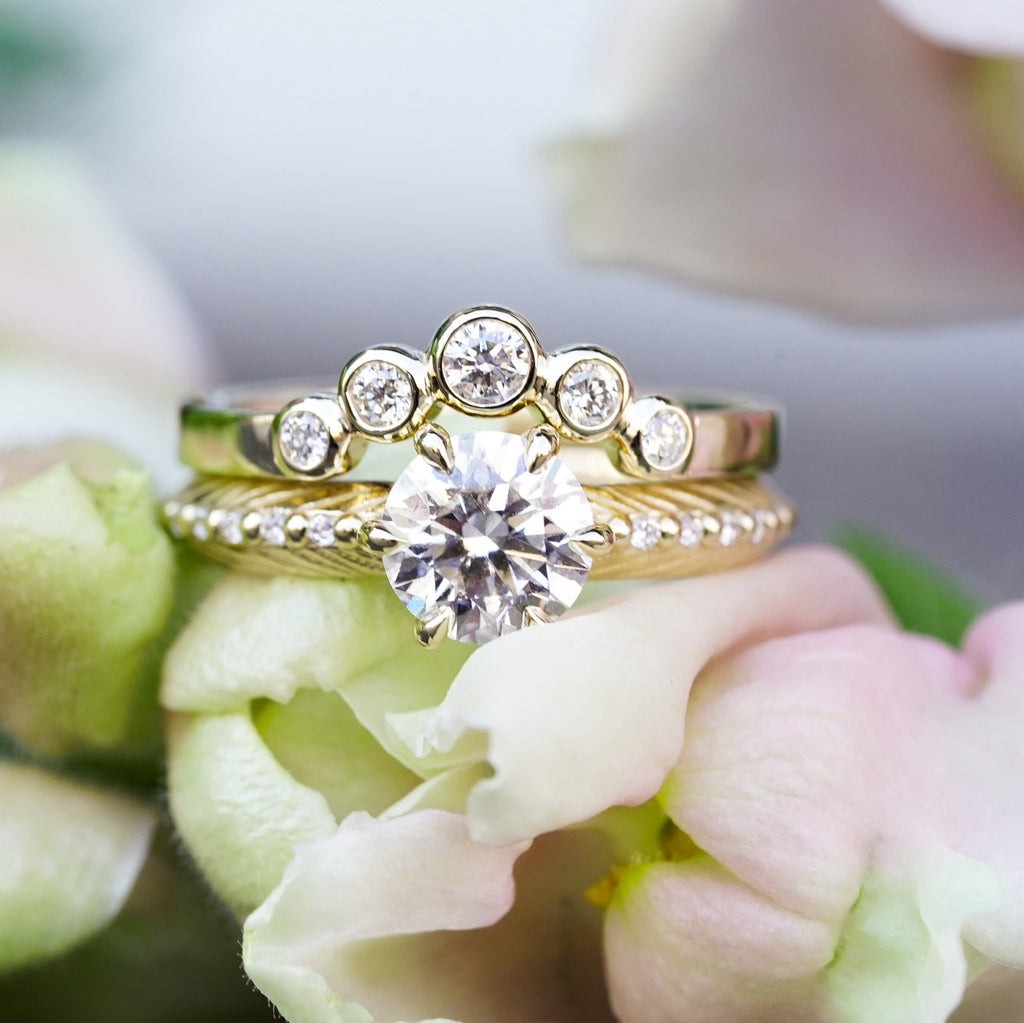 boho engagement ring with diamond and feather pattern with a round diamond contour band on top