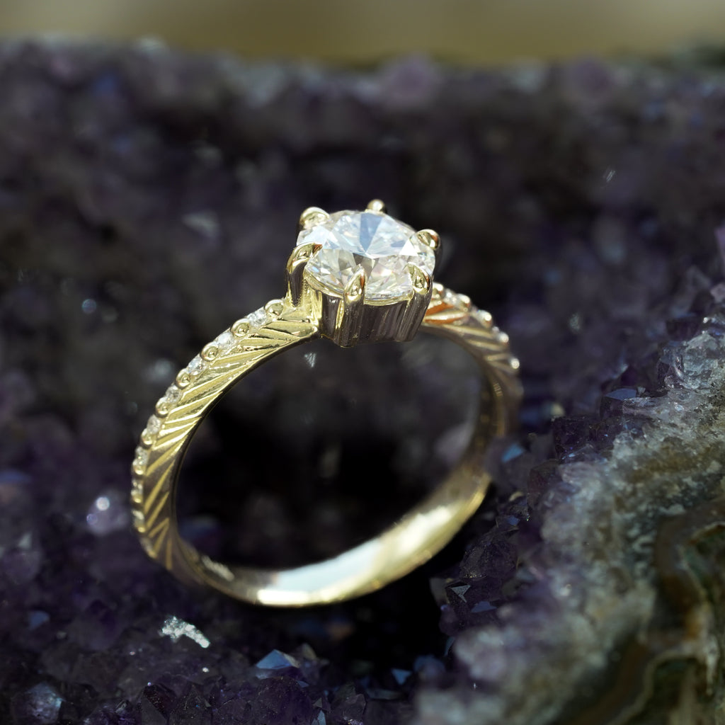 Brilliant cut white lab diamond prong set in yellow gold with feather and diamond detail for the boho bride