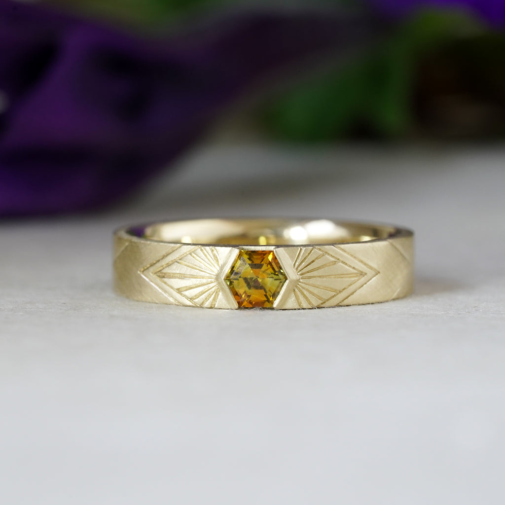 14k Yellow Gold orange montana hexagon sapphire in a radiating sunburst engraved wedding band