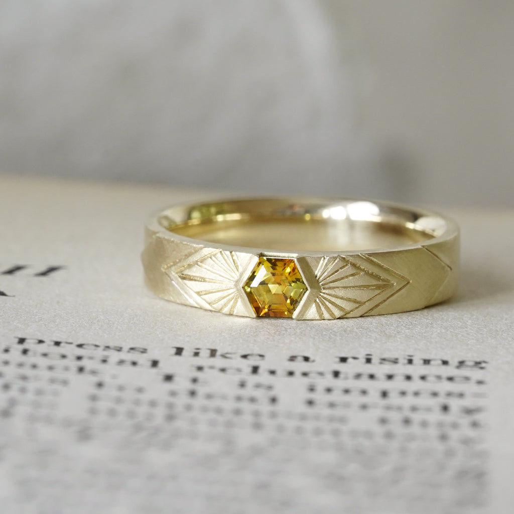 14k Yellow Gold orange montana hexagon sapphire in a radiating sunburst engraved wedding band