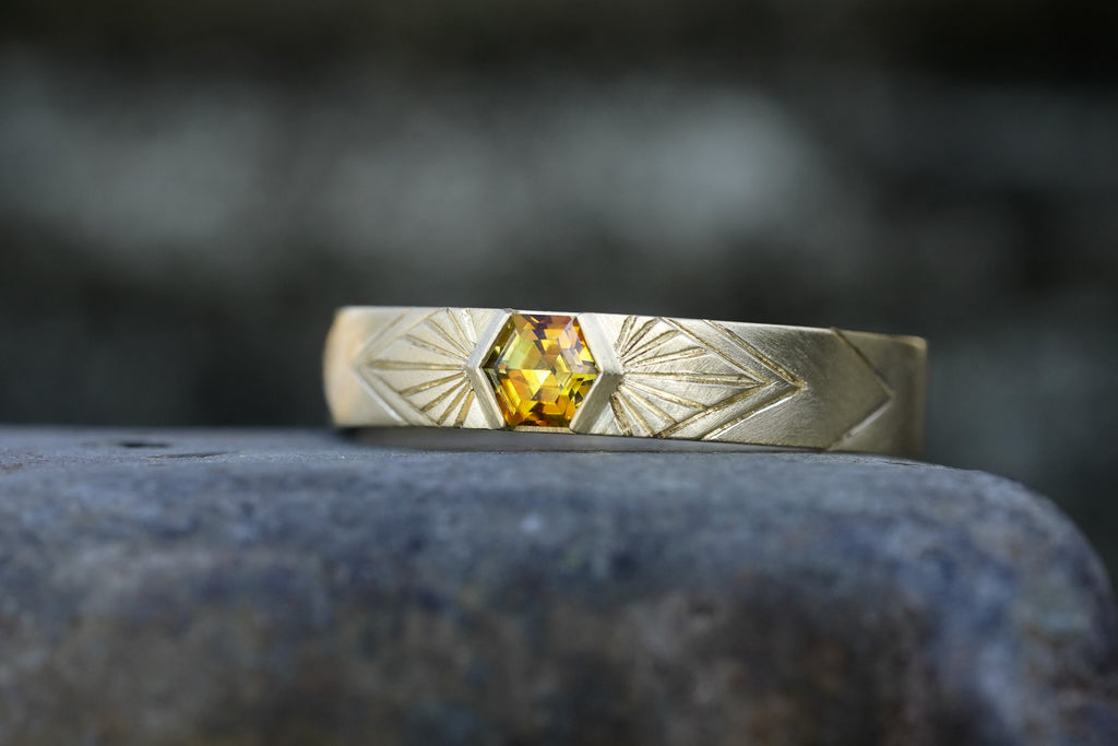 14k Yellow Gold orange montana hexagon sapphire in a radiating sunburst engraved wedding band