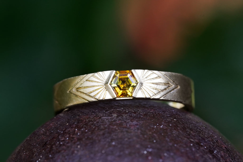 14k Yellow Gold orange montana hexagon sapphire in a radiating sunburst engraved wedding band