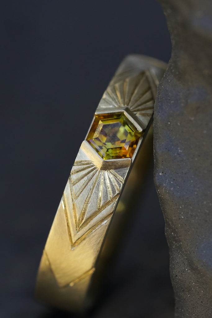 14k Yellow Gold orange montana hexagon sapphire in a radiating sunburst engraved wedding band