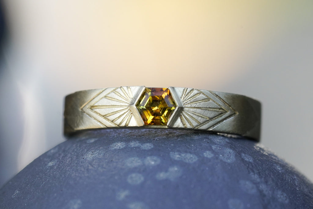 14k Yellow Gold orange montana hexagon sapphire in a radiating sunburst engraved wedding band