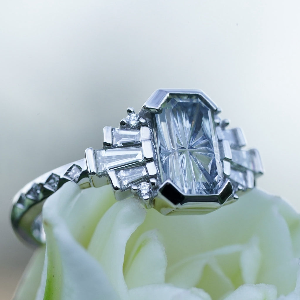 Geometric engagement ring with princess-cut diamond accents