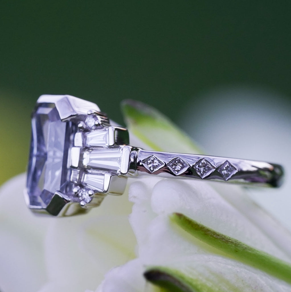 Geometric engagement ring with princess-cut diamond accents