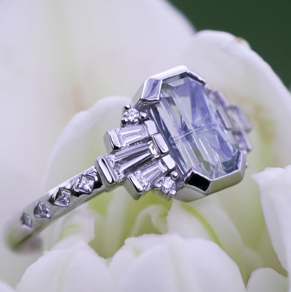 Geometric engagement ring with princess-cut diamond accents